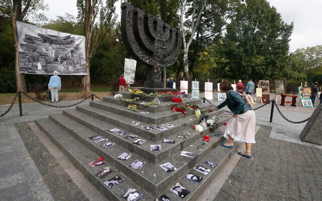 A woman lays flowers at a menorah monument close to the Babi Yar ravine where tens of thousands of Jews were killed during WWII. Photo: AP Photo/Efrem Lukatsky A woman lays flowers at a menorah monument close to the Babi Yar ravine where tens of thousands of Jews were killed during WWII. Photo: AP Photo/Efrem Lukatsky
