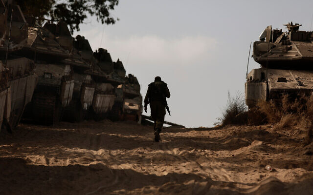 An Israeli soldier walks at a staging ground near the border with the Gaza Strip, in southern Israel, May 20, 2021. (AP Photo/Maya Alleruzzo) An Israeli soldier walks at a staging ground near the border with the Gaza Strip, in southern Israel, May 20, 2021. (AP Photo/Maya Alleruzzo)