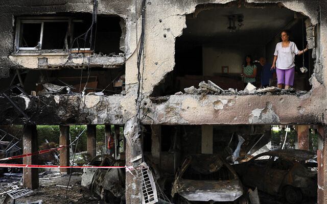 An apartment block hit by a rocket fired from the Gaza Strip in Petah Tikva. Photo: AP Photo/Oded Balilty An apartment block hit by a rocket fired from the Gaza Strip in Petah Tikva. Photo: AP Photo/Oded Balilty