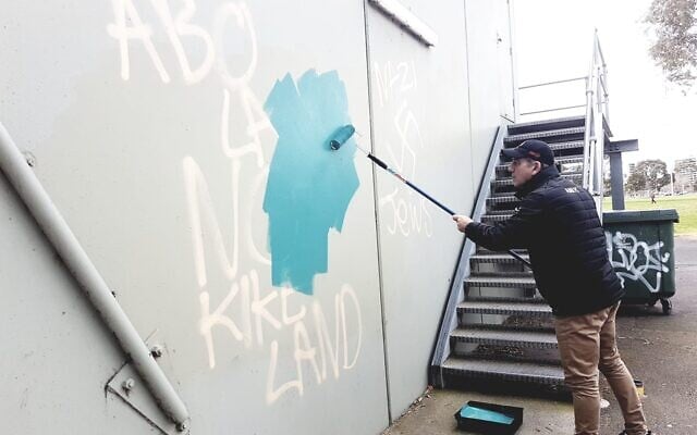 AJAX Football Club president Ronnie Lewis removing the graffiti on Sunday. Photo: Peter Haskin AJAX Football Club president Ronnie Lewis removing the graffiti on Sunday. Photo: Peter Haskin