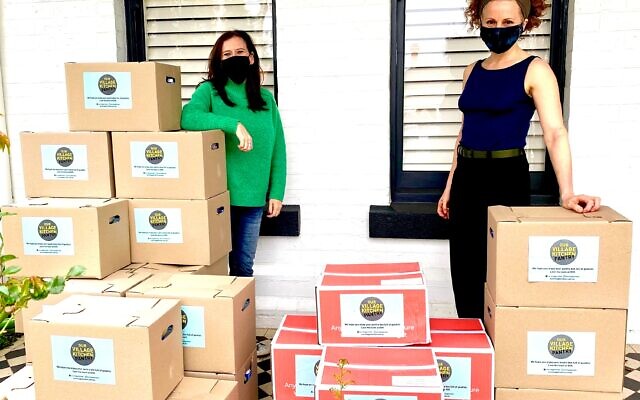 Our Village Kitchen’s Lisa Lipshut
(left) delivering Rosh Hashanah
boxes to Pathways’ Leah Bolton. Our Village Kitchen’s Lisa Lipshut
(left) delivering Rosh Hashanah
boxes to Pathways’ Leah Bolton.