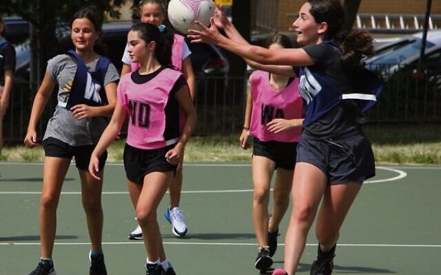 Maccabi netballer Ashley Urbach (with the ball) in a match earlier this year. Community sport can now resume in NSW. Photo: Shane Desiatnik Maccabi netballer Ashley Urbach (with the ball) in a match earlier this year. Community sport can now resume in NSW. Photo: Shane Desiatnik