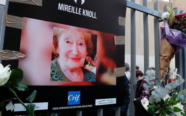 A photograph of murdered Holocaust survivor Mireille Knoll is placed along with flowers on the fence surrounding her building in Paris on March 28, 2018. Photo: AFP A photograph of murdered Holocaust survivor Mireille Knoll is placed along with flowers on the fence surrounding her building in Paris on March 28, 2018. Photo: AFP