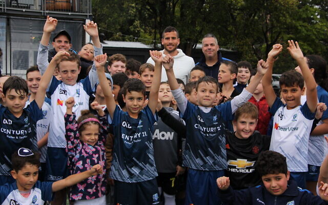 Tomer Hemed (back, wearing white) at a Maccabi-Hakoah Junior Football Club gala day at Easts Rugby Park last Sunday. Next to him is club president Dani Zaidel. Photo: Shane Desiatnik Tomer Hemed (back, wearing white) at a Maccabi-Hakoah Junior Football Club gala day at Easts Rugby Park last Sunday. Next to him is club president Dani Zaidel. Photo: Shane Desiatnik