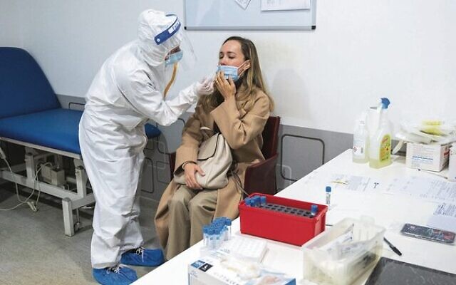 An Israeli traveller is tested for COVID-19 in Italy last month.
Photo: Yahav Gamliel/Flash90 An Israeli traveller is tested for COVID-19 in Italy last month.
Photo: Yahav Gamliel/Flash90