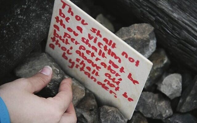 A March of the Living participant places a message on the railway tracks at Auschwitz.Photo: Emmanuel Santos A March of the Living participant places a message on the railway tracks at Auschwitz.Photo: Emmanuel Santos