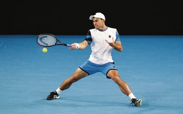 Russian Aslan Karatsev slides into a forehand against Mackenzie McDonald. Russian Aslan Karatsev slides into a forehand against Mackenzie McDonald.