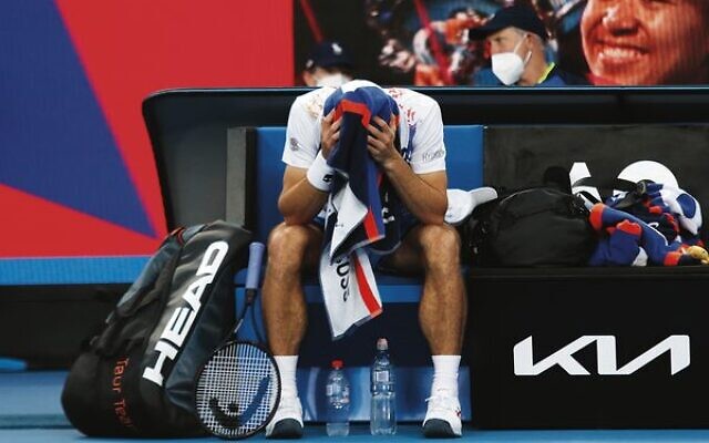 Down two sets to one, a worried Aslan Karatsev takes a break during his first-round match against Jaume Munar. Down two sets to one, a worried Aslan Karatsev takes a break during his first-round match against Jaume Munar.