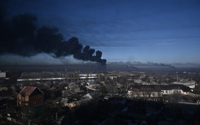 Black smoke rises from a military airport in Chuguyev near Kharkiv on February 24, 2022. Photo: Aris Messinis / AFP Black smoke rises from a military airport in Chuguyev near Kharkiv on February 24, 2022. Photo: Aris Messinis / AFP
