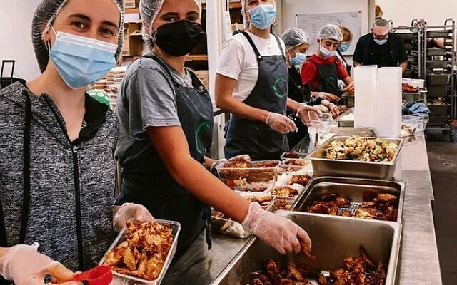 C Care volunteers preparing meals for vulnerable members of the community. C Care volunteers preparing meals for vulnerable members of the community.