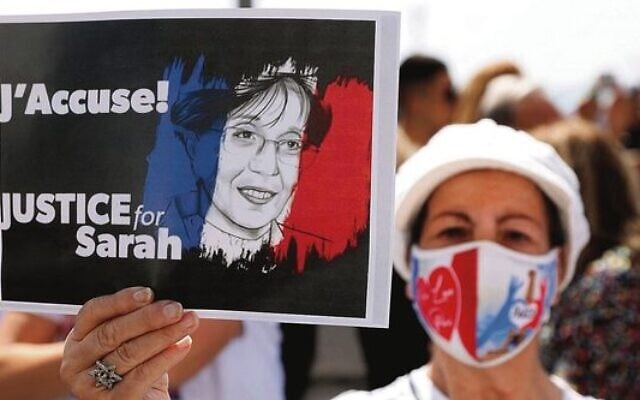 A woman holds up a sign during the day of rallies around the world protesting the French judicial system's handling of the Sarah Halimi case in April 2021. Photo: Jack Guez/AFP/Getty Images A woman holds up a sign during the day of rallies around the world protesting the French judicial system's handling of the Sarah Halimi case in April 2021. Photo: Jack Guez/AFP/Getty Images