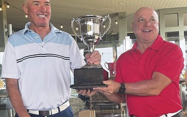 Maccabi Golf Australia president and team Victoria player Allen Garb (left) presenting the 2022 Maccabi President's Cup trophy to NSW captain Rob Wallhausen. Maccabi Golf Australia president and team Victoria player Allen Garb (left) presenting the 2022 Maccabi President's Cup trophy to NSW captain Rob Wallhausen.