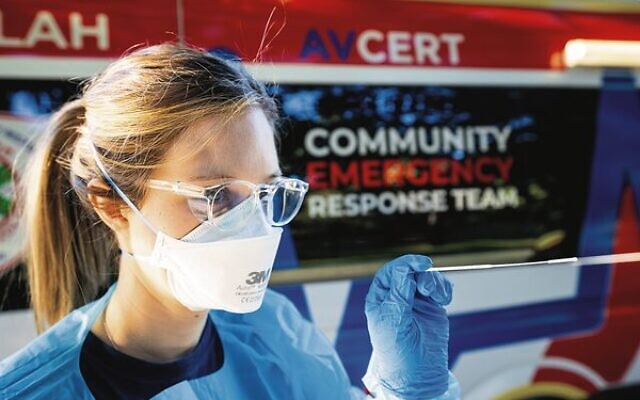 A Hatzolah responder performing a rapid antigen test. A Hatzolah responder performing a rapid antigen test.