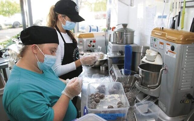 Laura Cameron and Jasmine Dale make biscuit balls. Photo: Gareth Narunsky Laura Cameron and Jasmine Dale make biscuit balls. Photo: Gareth Narunsky