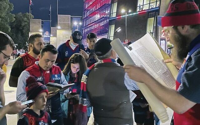 Rabbi Gutnick leads a Purim Megillah reading at the MCG. Rabbi Gutnick leads a Purim Megillah reading at the MCG.