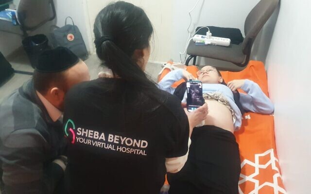 Pregnant patient and Ukrainian refugee Sarah Misk using Sheba Beyond’s telehealth technology in Kishinev, Moldova, March 2, 2022. (Sheba Medical Center) Pregnant patient and Ukrainian refugee Sarah Misk using Sheba Beyond’s telehealth technology in Kishinev, Moldova, March 2, 2022. (Sheba Medical Center)