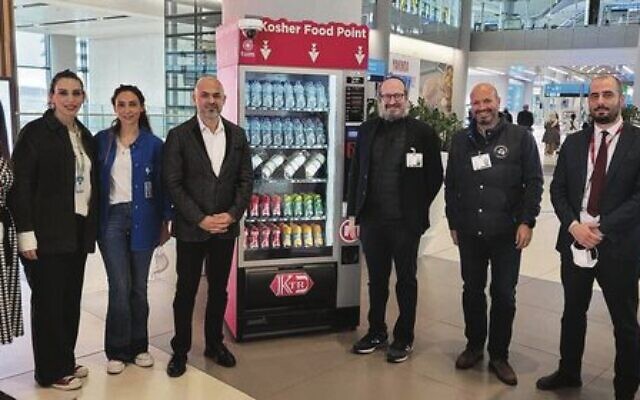 Rabbi Mendy Chitrick (third from right) next to the Istanbul Airport's new kosher vending machine. Rabbi Mendy Chitrick (third from right) next to the Istanbul Airport's new kosher vending machine.