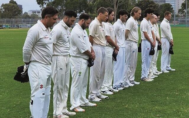 Maccabi-AJAX First XI players observing a minute's silence for Shane Warne. Maccabi-AJAX First XI players observing a minute's silence for Shane Warne.