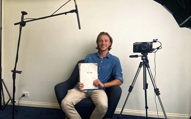 Daniel Delaway in his studio holding a discarded biography. Daniel Delaway in his studio holding a discarded biography.