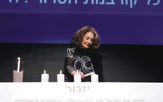 Hilary Friedland lights a candle for Eliyahu David Kay. Photo: Peter Haskin Hilary Friedland lights a candle for Eliyahu David Kay. Photo: Peter Haskin