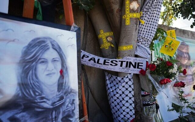 Yellow tape marks bullet holes on a tree and a portrait and flowers create a makeshift memorial at the site where Palestinian-American Al-Jazeera journalist Shireen Abu Akleh was shot and killed in Jenin in May.
Photo: AP/Majdi Mohammed Yellow tape marks bullet holes on a tree and a portrait and flowers create a makeshift memorial at the site where Palestinian-American Al-Jazeera journalist Shireen Abu Akleh was shot and killed in Jenin in May.
Photo: AP/Majdi Mohammed