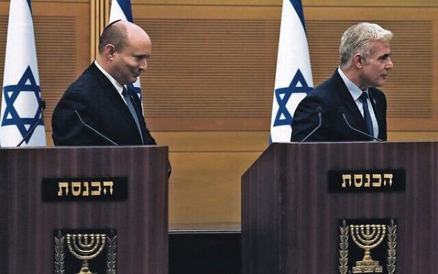 Israeli Prime Minister Naftali Bennett (left) and Foreign Minister Yair Lapid leave the podiums after their joint statement at the Knesset.
Photo: AP Photo/Maya Alleruzzo Israeli Prime Minister Naftali Bennett (left) and Foreign Minister Yair Lapid leave the podiums after their joint statement at the Knesset.
Photo: AP Photo/Maya Alleruzzo