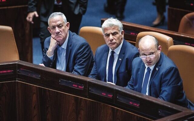 From left: Defence Minister Benny Gantz, Foreign Minister Yair Lapid and Prime Minister Naftali Bennett during a discussion and a vote on the vote on the "settler law bill" at the Knesset.Photo: Yonatan Sindel/Flash90 From left: Defence Minister Benny Gantz, Foreign Minister Yair Lapid and Prime Minister Naftali Bennett during a discussion and a vote on the vote on the "settler law bill" at the Knesset.Photo: Yonatan Sindel/Flash90