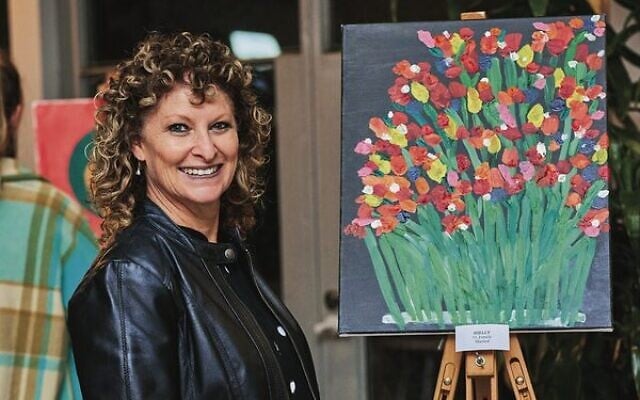 Shelly Spilkin next to her painting of 'love'. Shelly Spilkin next to her painting of 'love'.
