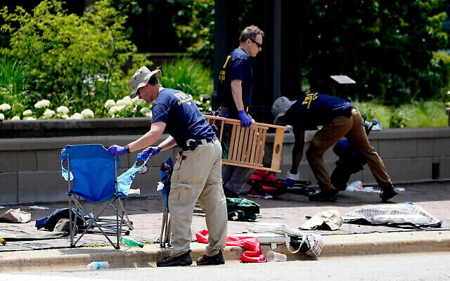 Members of the FBI's evidence response team remove personal belongings one day after a mass shooting in downtown Highland Park. Photo: AP Photo/Charles Rex Arbogast Members of the FBI's evidence response team remove personal belongings one day after a mass shooting in downtown Highland Park. Photo: AP Photo/Charles Rex Arbogast