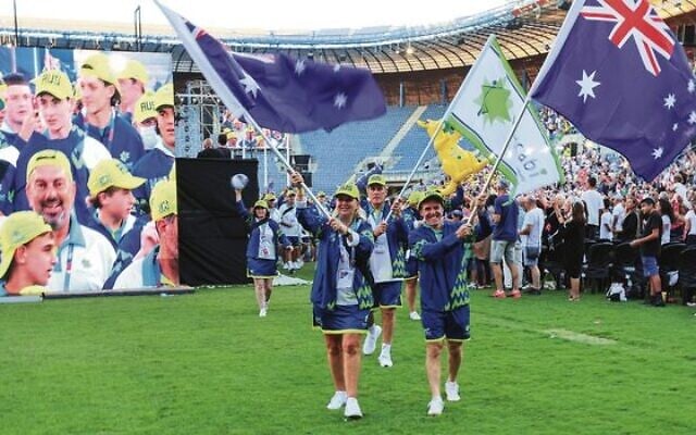 Australia's flagbearers Lauren Ehrlich (left) and Jonathan Pillemer lead the way into Jerusalem's Teddy Stadium for the Maccabiah Games opening ceremony on July 14, followed by Jeff Sher carrying the Maccabi Australia flag. Photo: Robi Karp/Maccabi Australia Media Australia's flagbearers Lauren Ehrlich (left) and Jonathan Pillemer lead the way into Jerusalem's Teddy Stadium for the Maccabiah Games opening ceremony on July 14, followed by Jeff Sher carrying the Maccabi Australia flag. Photo: Robi Karp/Maccabi Australia Media