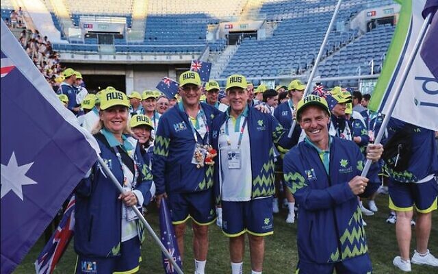 Australia's flagbearers Lauren Ehrlich (left) and Jonathan Pillemer (right) inside Jerusalem's Teddy Stadium at the start of the Maccabiah Games opening ceremony on July 14. Pictured in centre are Australia's head of delegation Barry Smorgon (left), and Maccabi Australia president and Maccabi flag carrier, Jeff Sher.   Photo: Robi Karp/Maccabi Australia Media