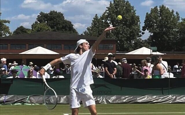 Jake Dembo serving in a 2022 Junior Wimbledon U14 boys' match earlier this week. Jake Dembo serving in a 2022 Junior Wimbledon U14 boys' match earlier this week.