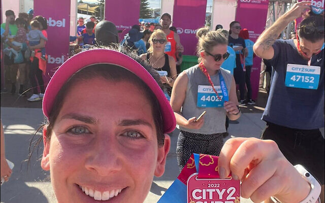 Maccabi-JCA community team member Robyn Goldin at the City2Surf finish line last Sunday at Bondi Beach. Maccabi-JCA community team member Robyn Goldin at the City2Surf finish line last Sunday at Bondi Beach.