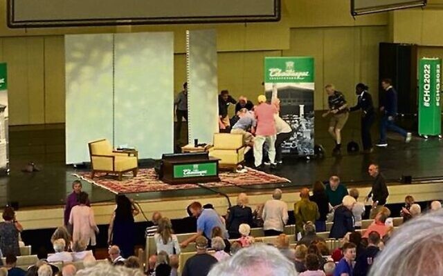 The aftermath of the stabbing attack on author Salman Rushdie at the Chautauqua Institution in western New York, August 12, 2022. Organisers gather around Rushdie, who suffered severe injuries in the attack. Photo: Courtesy Rabbi Charles Savenor The aftermath of the stabbing attack on author Salman Rushdie at the Chautauqua Institution in western New York, August 12, 2022. Organisers gather around Rushdie, who suffered severe injuries in the attack. Photo: Courtesy Rabbi Charles Savenor