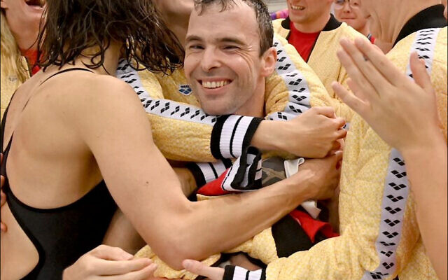 Retiring Australian Paralympian Matt Levy is congratulated by his teammates after his final event - the Duel in the Pool - in Sydney on August 21. Photo: Swimming Australia Retiring Australian Paralympian Matt Levy is congratulated by his teammates after his final event - the Duel in the Pool - in Sydney on August 21. Photo: Swimming Australia