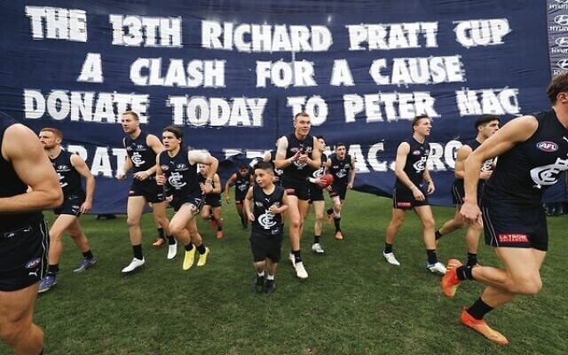 David Akoka (centre) running with the Carlton football team. David Akoka (centre) running with the Carlton football team.