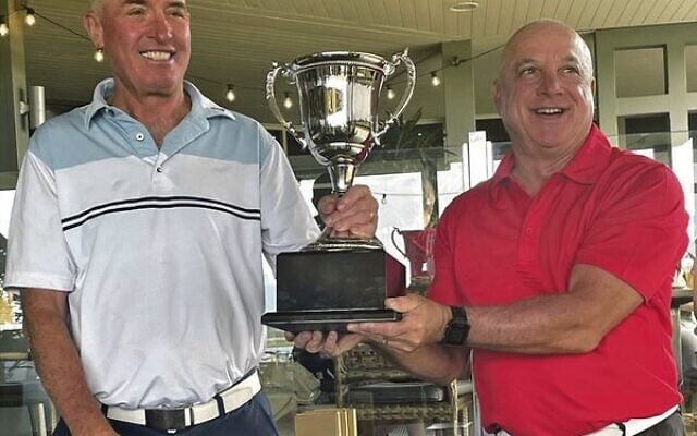 Maccabi Golf Australia president Allen Garb presenting NSW men's captain Rob Walhausen with the 2022 Presidents Cup trophy. Maccabi Golf Australia president Allen Garb presenting NSW men's captain Rob Walhausen with the 2022 Presidents Cup trophy.