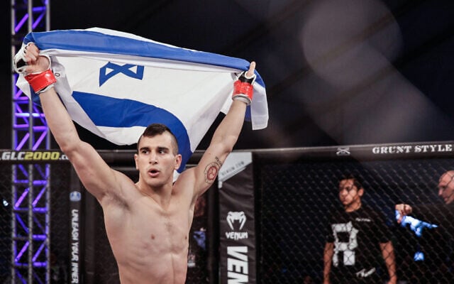 Natan Levy proudly shows an Israeli flag before his matches. Photo: Amy Kaplan Natan Levy proudly shows an Israeli flag before his matches. Photo: Amy Kaplan