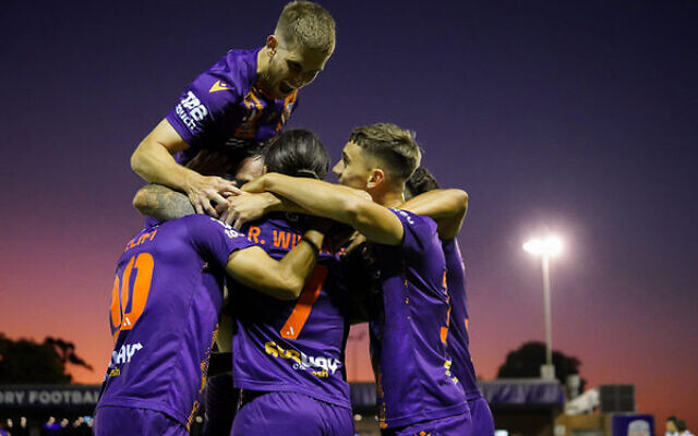Jacob Muir atop a Perth Glory team huddle after their win last week against reigning premiers Western United. Photo: Estybsphoto Jacob Muir atop a Perth Glory team huddle after their win last week against reigning premiers Western United. Photo: Estybsphoto