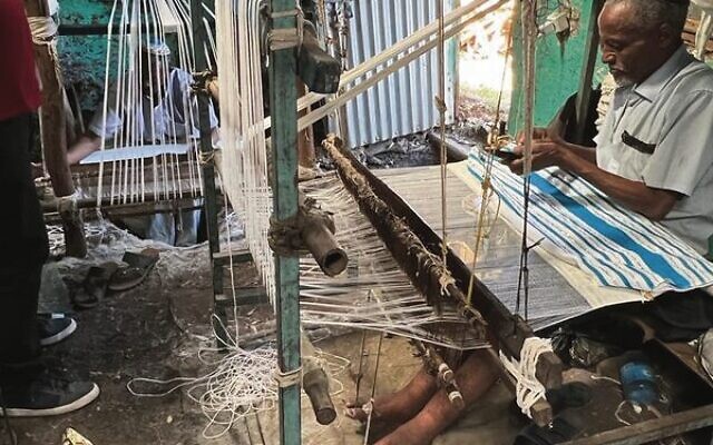 An Ethiopian man makes a tallit. An Ethiopian man makes a tallit.