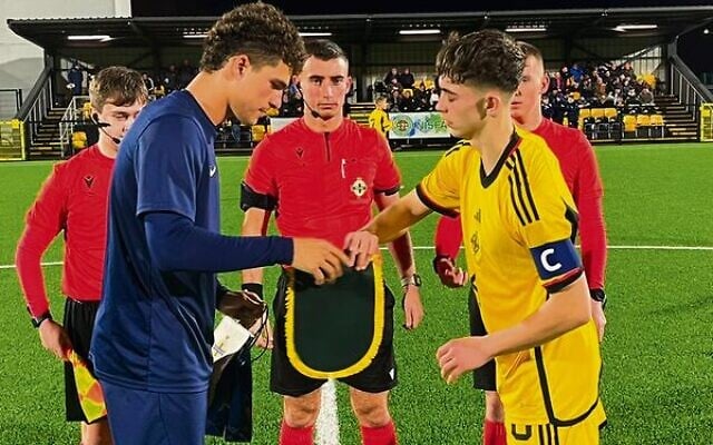 Aden Green (left) shaking hands with the Northern Ireland Schoolboys' captain in East Belfast on January 23. Aden Green (left) shaking hands with the Northern Ireland Schoolboys' captain in East Belfast on January 23.