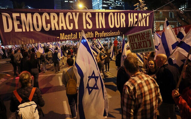 Demonstrators attend a protest against the Israeli government's controversial judicial reform bill in Tel Aviv on March 11, 2023. (Photo by JACK GUEZ / AFP) Demonstrators attend a protest against the Israeli government's controversial judicial reform bill in Tel Aviv on March 11, 2023. (Photo by JACK GUEZ / AFP)