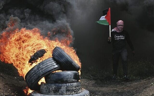 Palestinian protesters burn tyres during a Hamas protest east of Gaza City against the regional summit in Sharm el-Sheikh, Egypt. Photo: Mahmud Hams/AFP Palestinian protesters burn tyres during a Hamas protest east of Gaza City against the regional summit in Sharm el-Sheikh, Egypt. Photo: Mahmud Hams/AFP