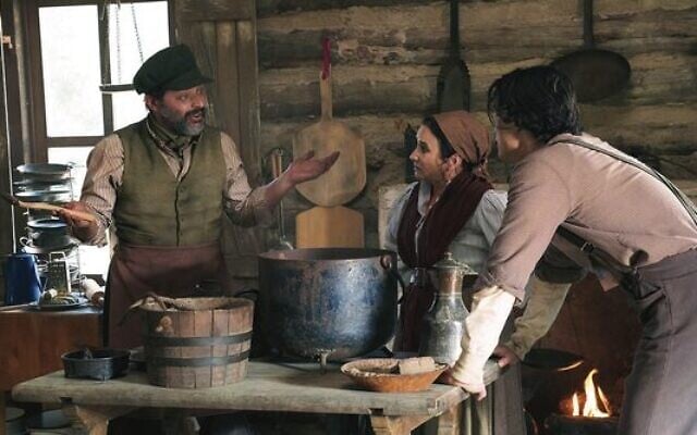 Schmuck Mudman (Nick Kroll), Fanny (Pamela Adlon) and Joshy (Charles Melton) discuss leaving the shtetl as the Russian Revolution breaks out in History of the World Part II. Photo: Hulu via JTA Schmuck Mudman (Nick Kroll), Fanny (Pamela Adlon) and Joshy (Charles Melton) discuss leaving the shtetl as the Russian Revolution breaks out in History of the World Part II. Photo: Hulu via JTA