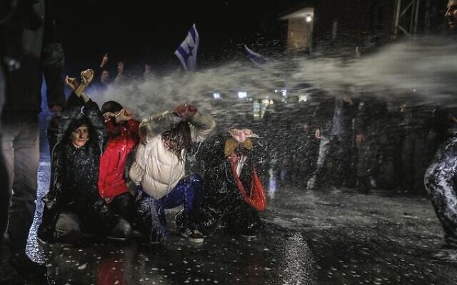 Police use water cannons to disperse protesters outside Prime Minister Benjamin Netanyahu's residence in Jerusalem on March 26. Photo: Noam Revkin Fenton/Flash90 Police use water cannons to disperse protesters outside Prime Minister Benjamin Netanyahu's residence in Jerusalem on March 26. Photo: Noam Revkin Fenton/Flash90