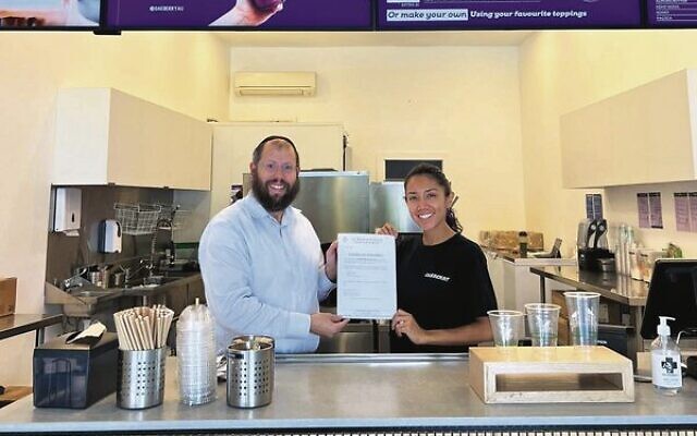 Rabbi Aaron Groner presenting the Certificate of Kashrut to the new store in Rose Bay. Photo: Facebook. Rabbi Aaron Groner presenting the Certificate of Kashrut to the new store in Rose Bay. Photo: Facebook.