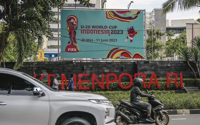 Motorists commute past a poster for the Indonesia 2023 FIFA Under-20 World Cup football tournament in Jakarta on March 30. Photo: Bay Ismoyo/AFP Motorists commute past a poster for the Indonesia 2023 FIFA Under-20 World Cup football tournament in Jakarta on March 30. Photo: Bay Ismoyo/AFP