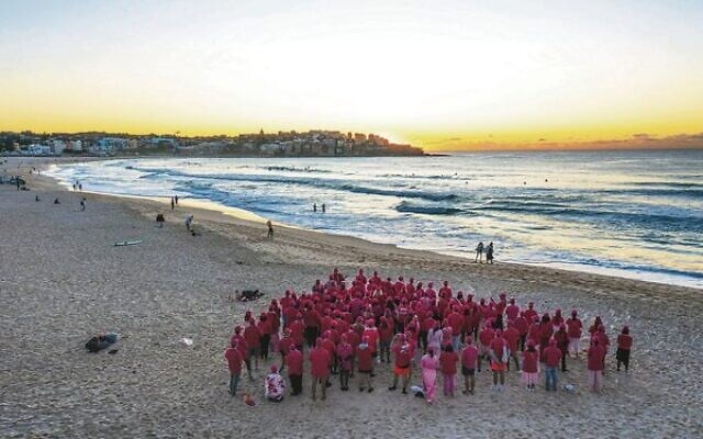 Remember the Yom volunteers, forming a pink triangle at sunrise at Bondi Beach on March 30.
Photo: Airview Online, taken from a drone Remember the Yom volunteers, forming a pink triangle at sunrise at Bondi Beach on March 30.
Photo: Airview Online, taken from a drone