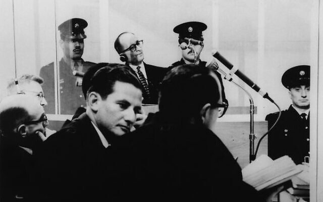 Adolf Eichmann listens to the proceedings during his trial through a glass booth. Photo: USHMM. Adolf Eichmann listens to the proceedings during his trial through a glass booth. Photo: USHMM.