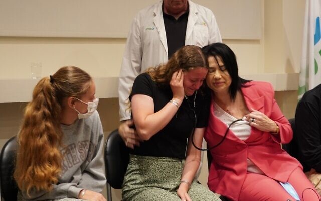 Keren Dee listens to her mother, Lucy Dee's heart, beating in Tali Valencia who received a donor transplant after Lucy was killed in a terror attack. Credit: Jotam Confino Keren Dee listens to her mother, Lucy Dee's heart, beating in Tali Valencia who received a donor transplant after Lucy was killed in a terror attack. Credit: Jotam Confino
